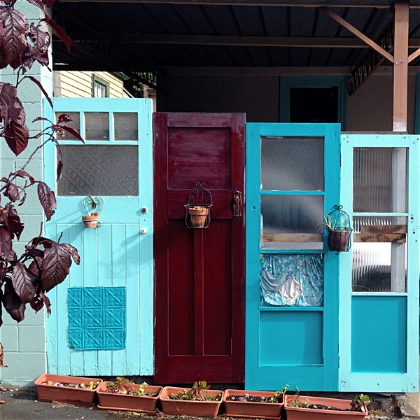 four painted doors in a row and leading nowhere