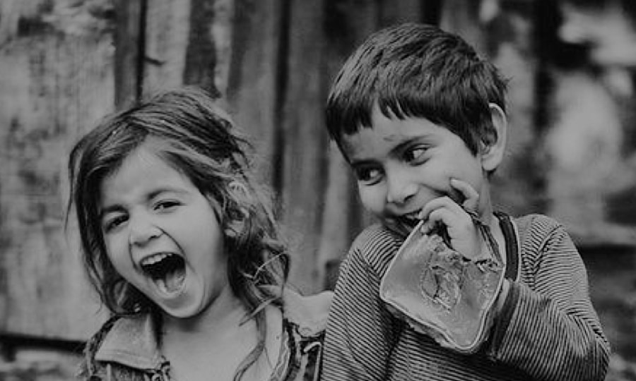 faces of two children in ragged clothes