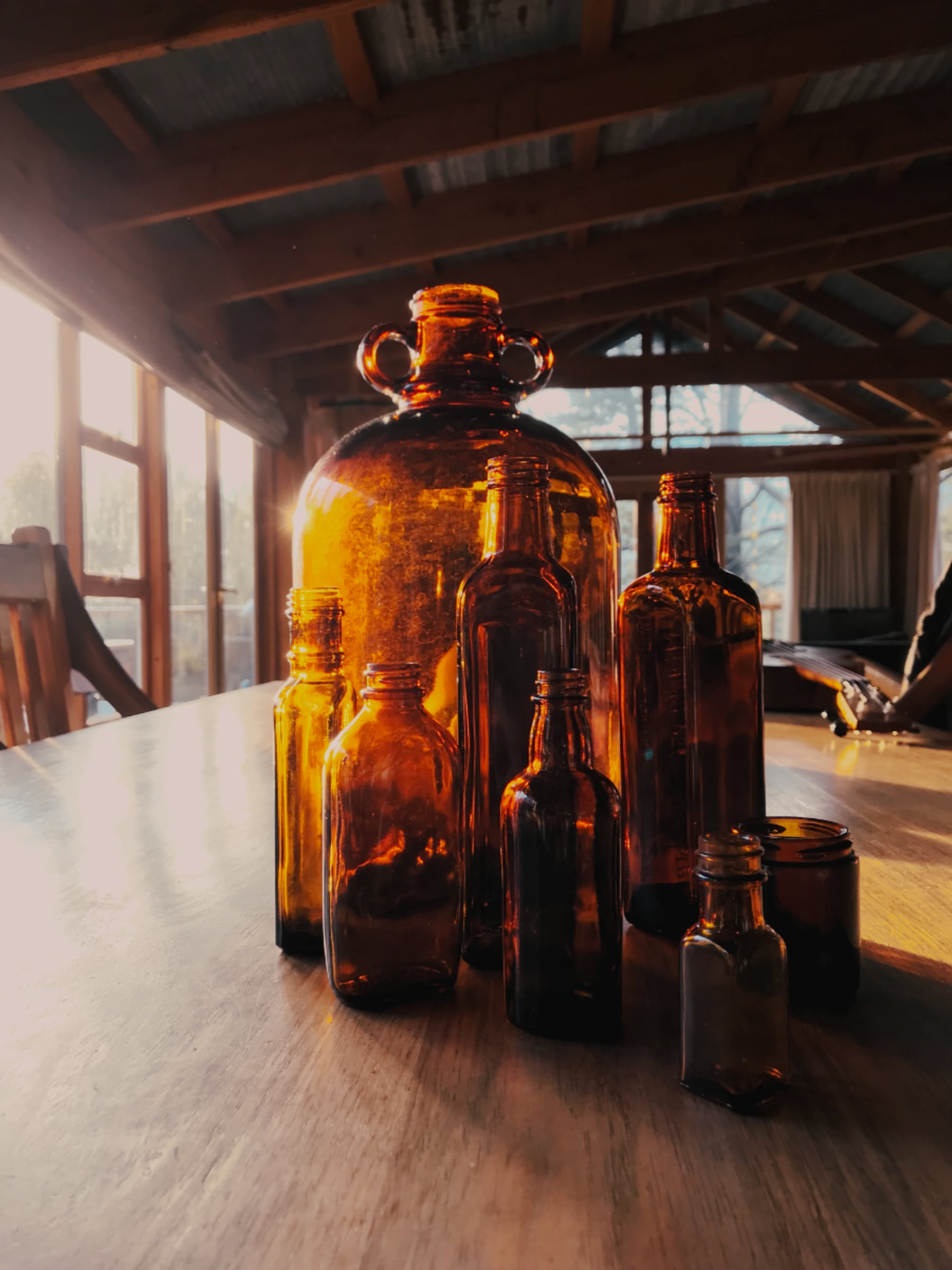 empty brown bottles on a wooden table