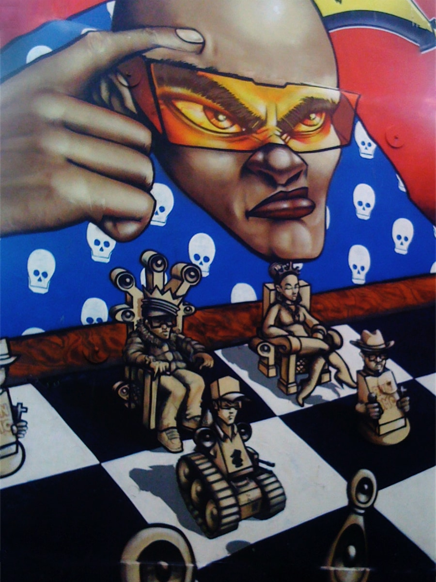 graffiti thinker with amber shades plans next move on chess board