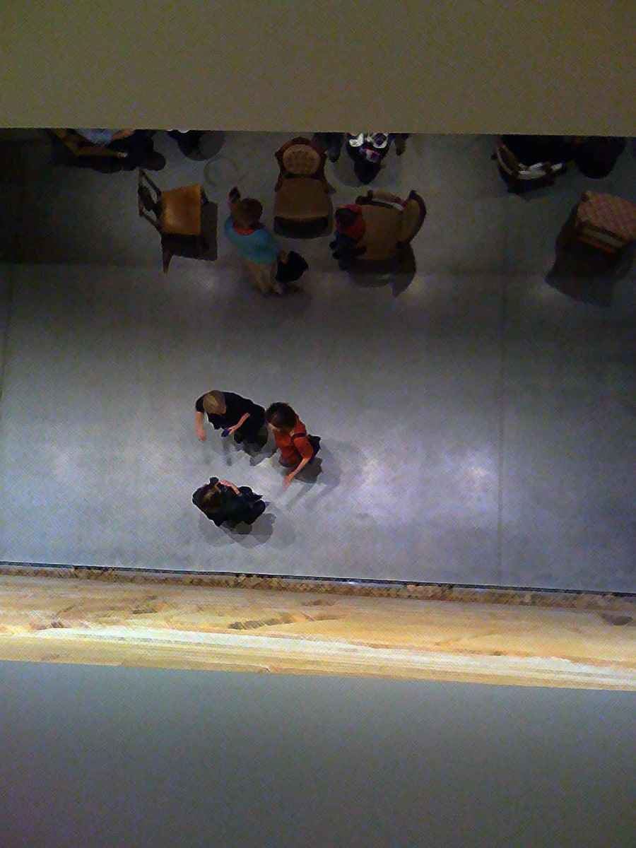 overhead view of women standing in gallery, talking