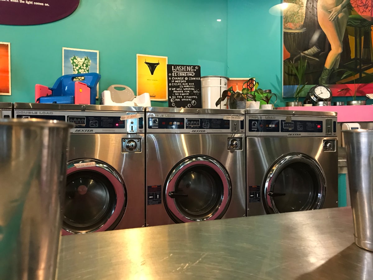 washing machines in cafe with art work