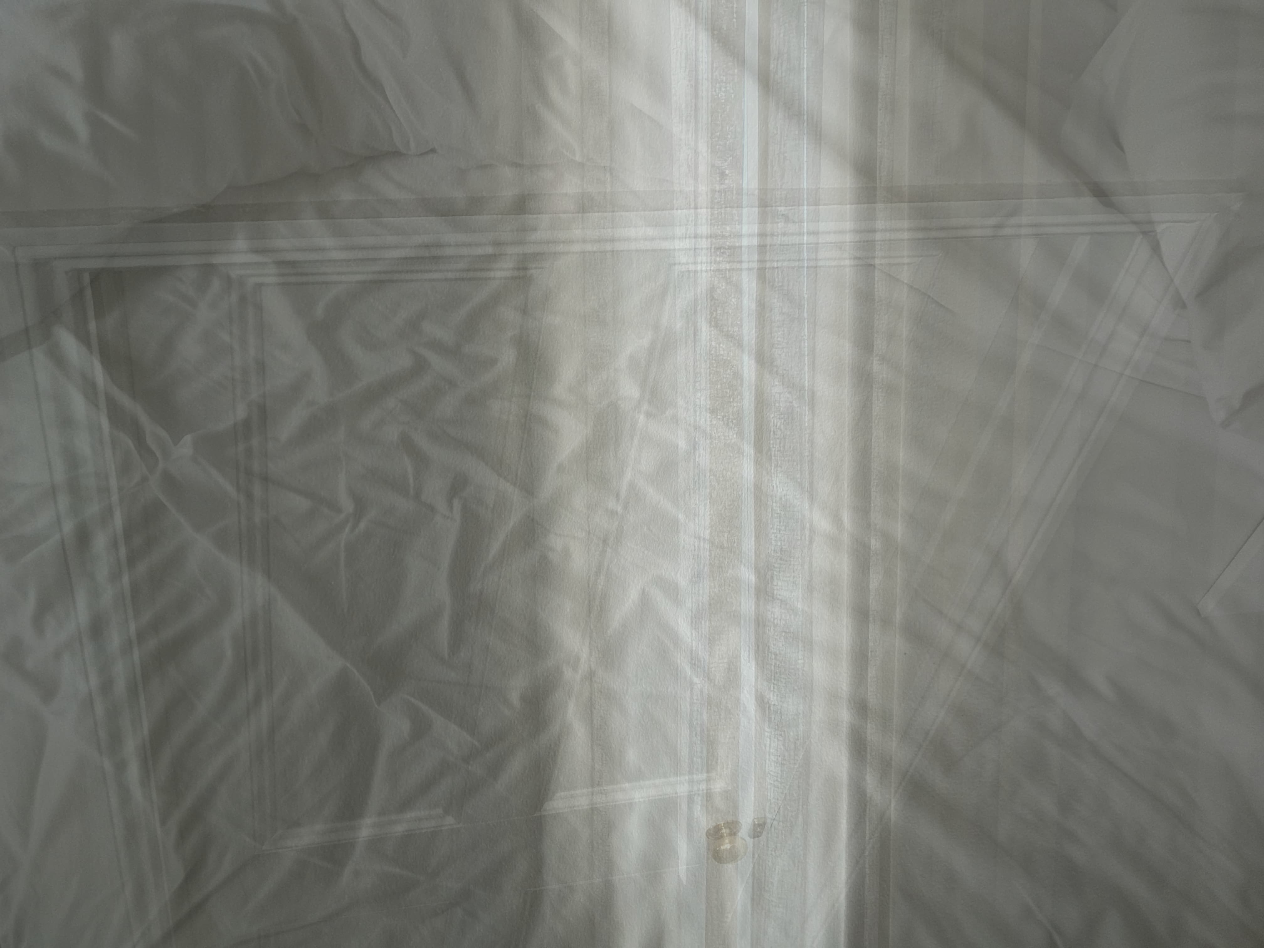 white doorways through white sheets